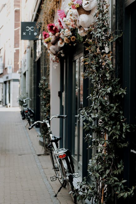 A floral arrangement of mixed flowers including pink and white blooms, possibly roses and carnations, is displayed above the entrance of a storefront on Eccleston Street. The bouquet is lush and arran